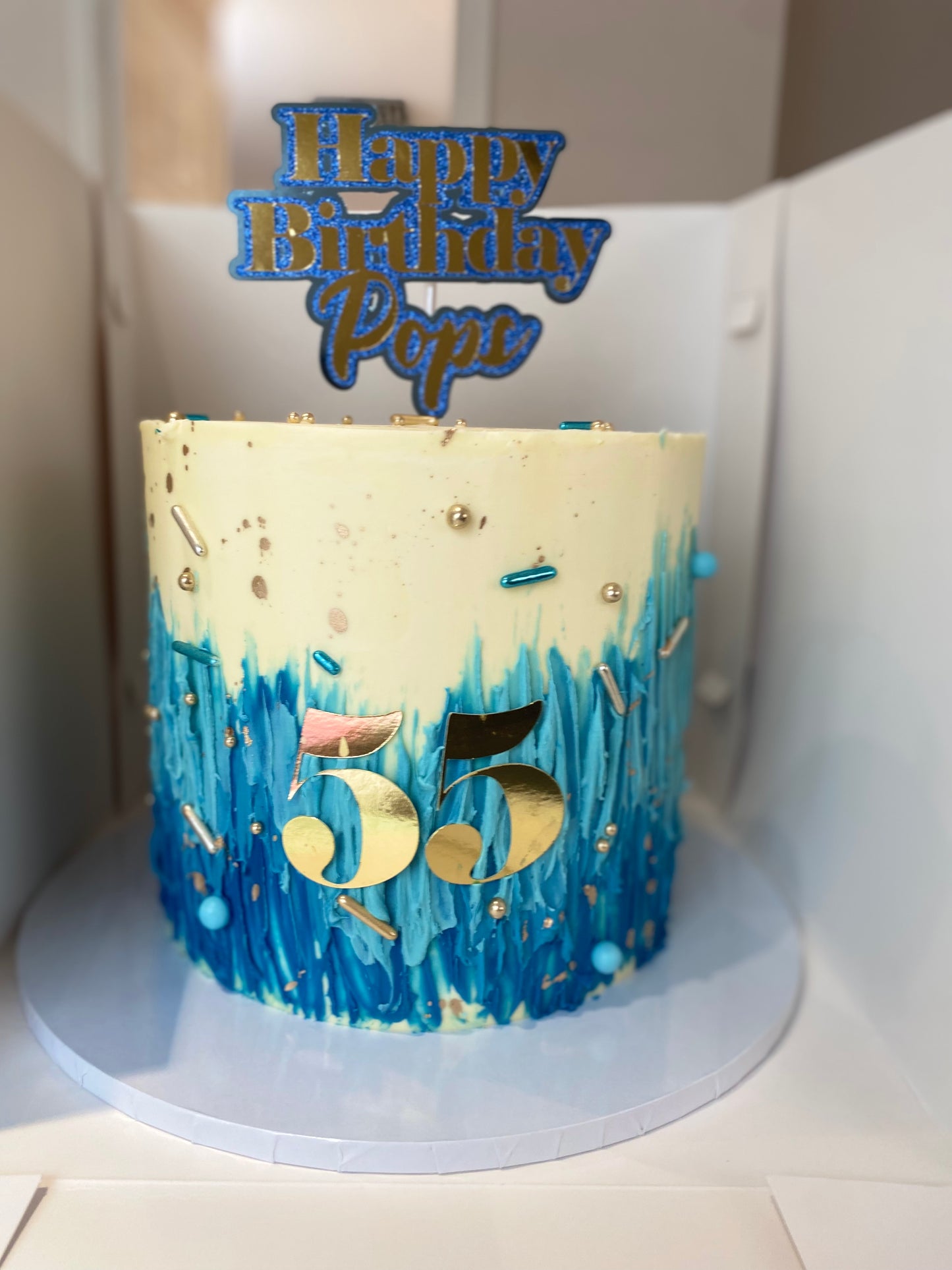 Blue ombré, cream and gold cake