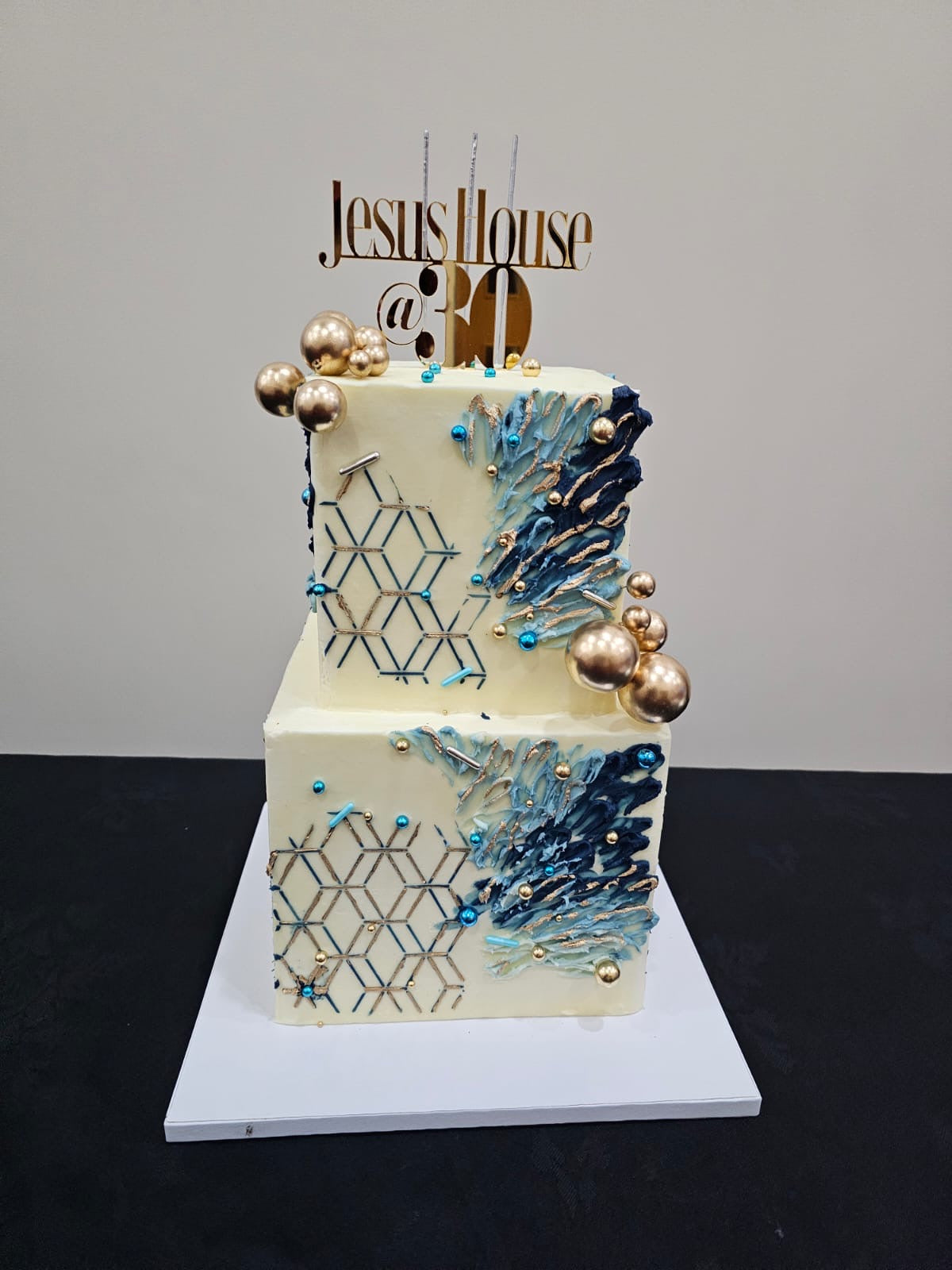 Blue square 2-tier buttercream cake with abstract design