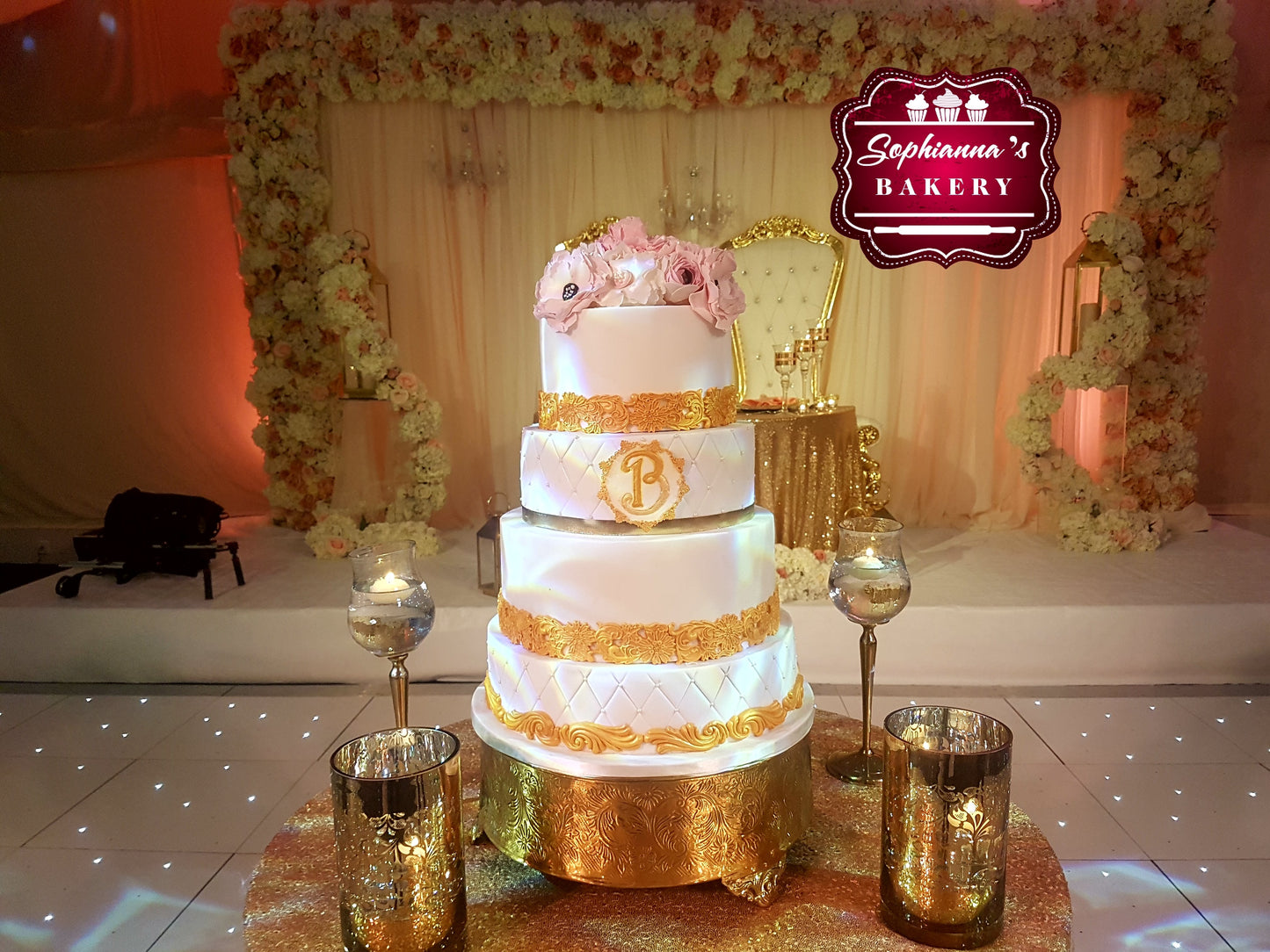 Four-tier gold and white wedding cake